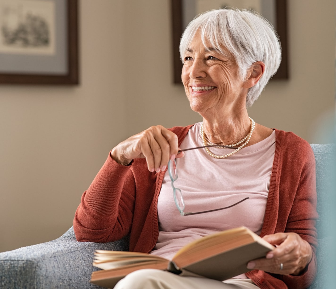 smiling old woman holding a book